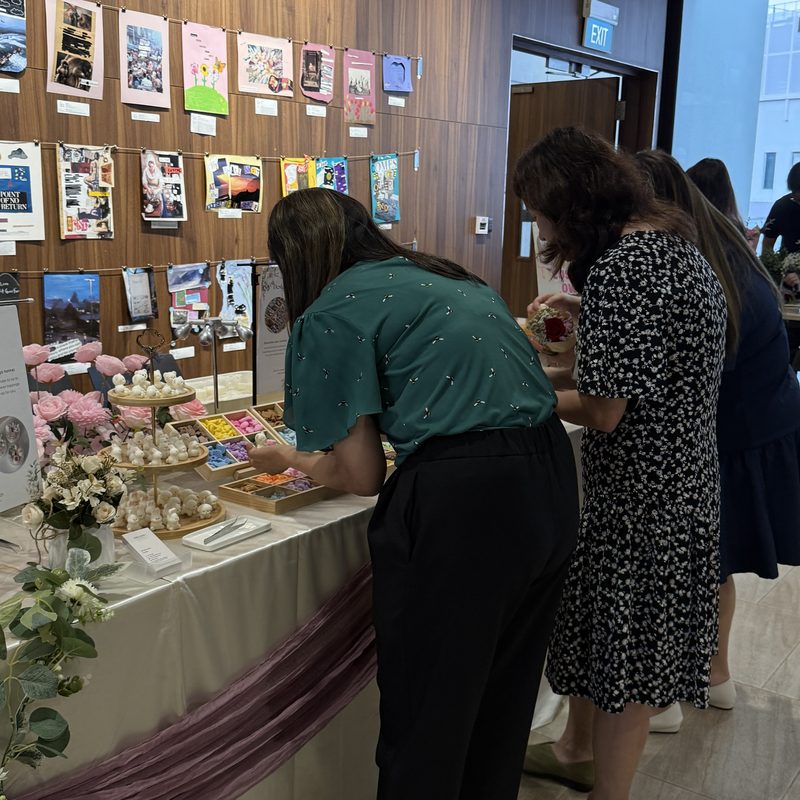 Guests choose wax toppings at a White Pixies decorating station with trays of colourful wax pieces