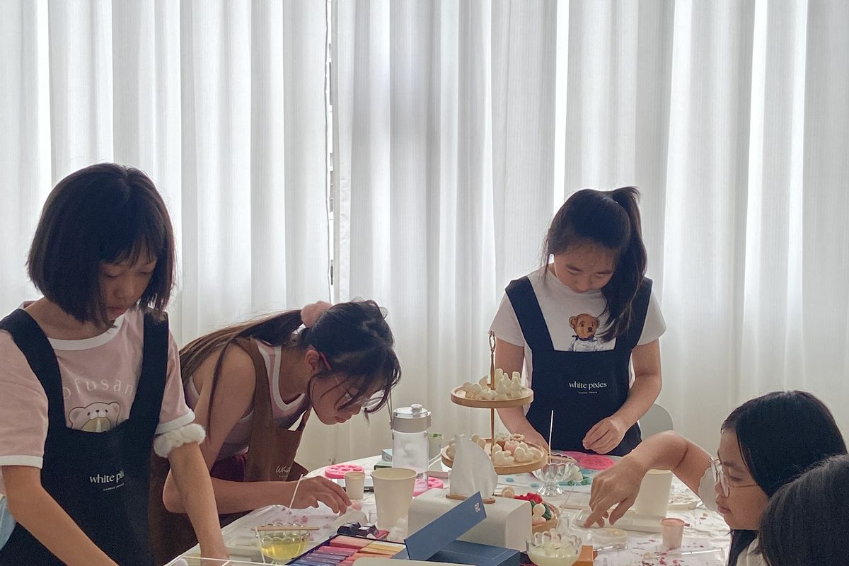Young guests decorate their own candles at the White Pixies studio in Singapore
